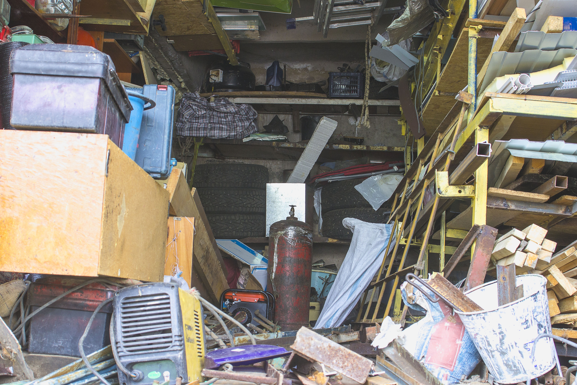 Big mess in an over stuffed suburban garage.